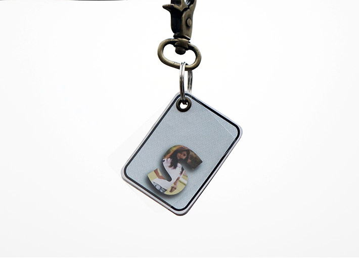 A custom made key chain gift hanging with Name letters with pictures.