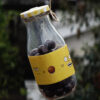 mini bottle with chocolates inside it and yellow sticker with doodles