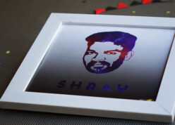 white square frame placed on a sheet with red and black banner in the background