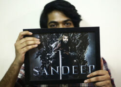 guy holding his photo frame edited in iron throne king theme with his name printed on it