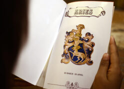 girl looking at her zodiac sign printed on greeting cards