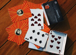 Face logo, custom pack of cards with stylish box spread on a table