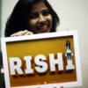 girl smiling at her edited name frame with her photo on top of alphabet in a white frame