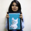 girl holding her pet's portrait in her hands and smiling
