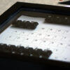 Black key board keys making words to form a message in a unique black frame.