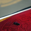 close up view of Aries zodiac sign printed on 300gsm card with red background