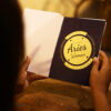 Girl reading zodiac sign greeting card gift in a drive-in