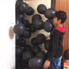 Balloons rushing inside the room to surprise a boy