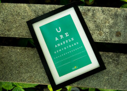 a4 size black mount frame with custom text that appears as sight test placed on bench