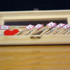 pine wood with transparent glass to it opened with peg clips inside the box