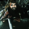 close up of guy's face edited on a king's body holding his weapon