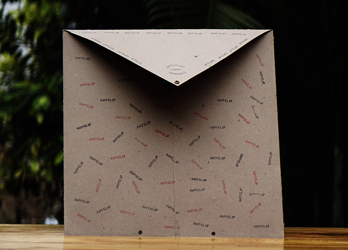 Brown envelope with red and black happiclap brand stamps all over