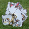 circular spread of picture letter key chain on grass.