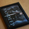a4 size black frame with game of thrones edited photo placed on brown sheet with decorative banner