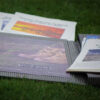 close up of handmade grey book with tourist places printed papers