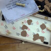 love cut outs and couple names stamped inside a wooden chess board with custom message note