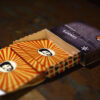 Stalk of comic face printed playing cards in a name designed custom box