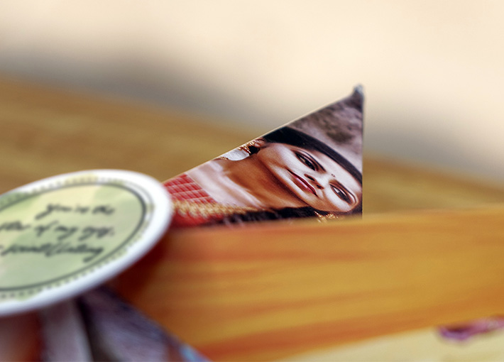 Close view of a side of a 3D star with girl's pictures on it and a wishing quote card at its center.